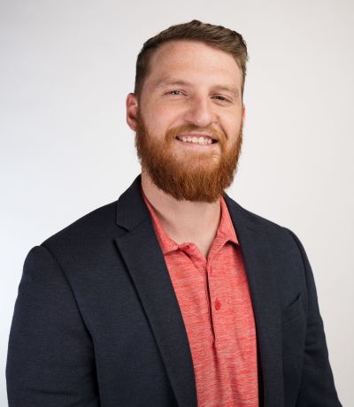 Spencer Appleton A smiling man with a red beard and short brown hair, wearing a dark blue blazer over a red polo shirt, identified as Spencer Appleton, Project Development Specialist. His favorite product is Bomb Pop® Sno.