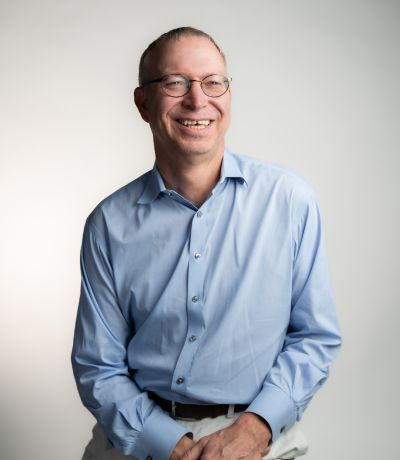 Untitled design (2) A smiling man with short, thinning hair and glasses wears a light blue button-up shirt and light pants, identified as Eric Lee, CFO. His favorite product is Mangonada Sno.