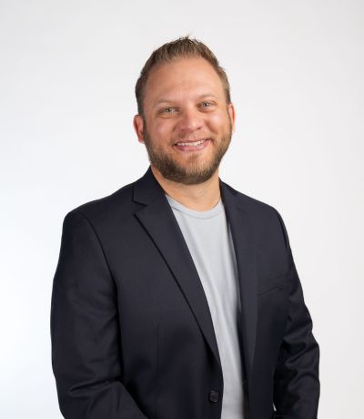 Andrew Packer A smiling man with a beard and short, light brown hair wears a dark suit jacket over a light gray shirt, identified as Andrew Packer, Chief Strategy Officer. His favorite product is Strawberry/Natural Pineapple BRM with Gummy Bears