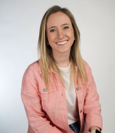 Stephanie Knox A smiling woman with long, blonde hair wearing a light pink jacket over a white top and a gold chain necklace, identified as Stephanie Knox, IT Project Specialist. Her favorite product is Electric Lemon Refresher.