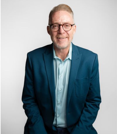 Blake Buchanan A professional headshot of a smiling man with short, light hair and glasses wearing a blue suit jacket and light blue shirt, identified as Blake Buchanan, CEO, President. His favorite product is Cherry Cola BRM with Vanilla Ice Cream.